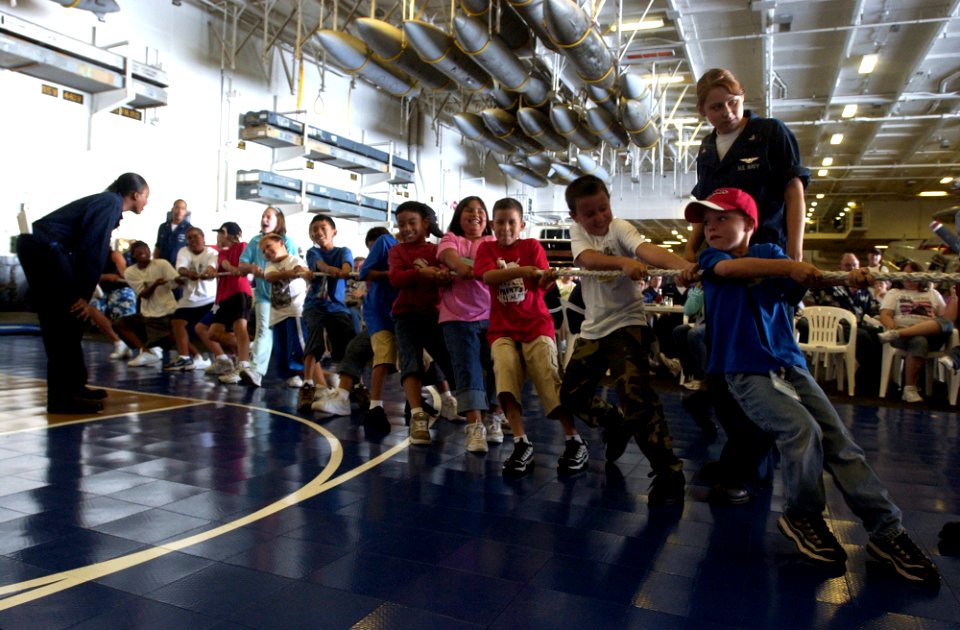 US Navy 060703-N-7130B-260 In the hangar bay aboard the Nimitz-class aircraft carrier USS Ronald Reagan (CVN 76), children of crew members play tug-o-war during a Tiger Cruise