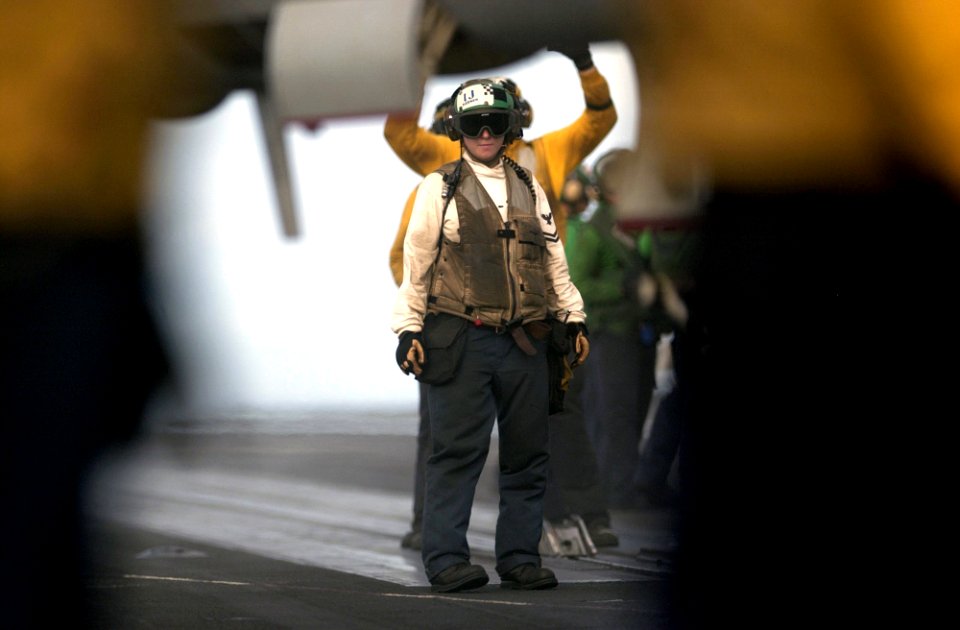 US Navy 060622-N-7130B-147 An aircraft troubleshooter assigned to the Fighting Redcocks of Strike Fighter Squadron Twenty-two (VFA-22) waits for an F-A-18E Super Hornet to be moved into launch position