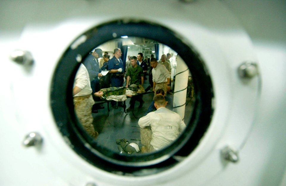 US Navy 060817-N-4482V-005 Members of Expeditionary Strike Group Five's (ESG-5) medical team, attached to USS Boxer (LHD 4), assist wounded Marines during a mass casualty drill