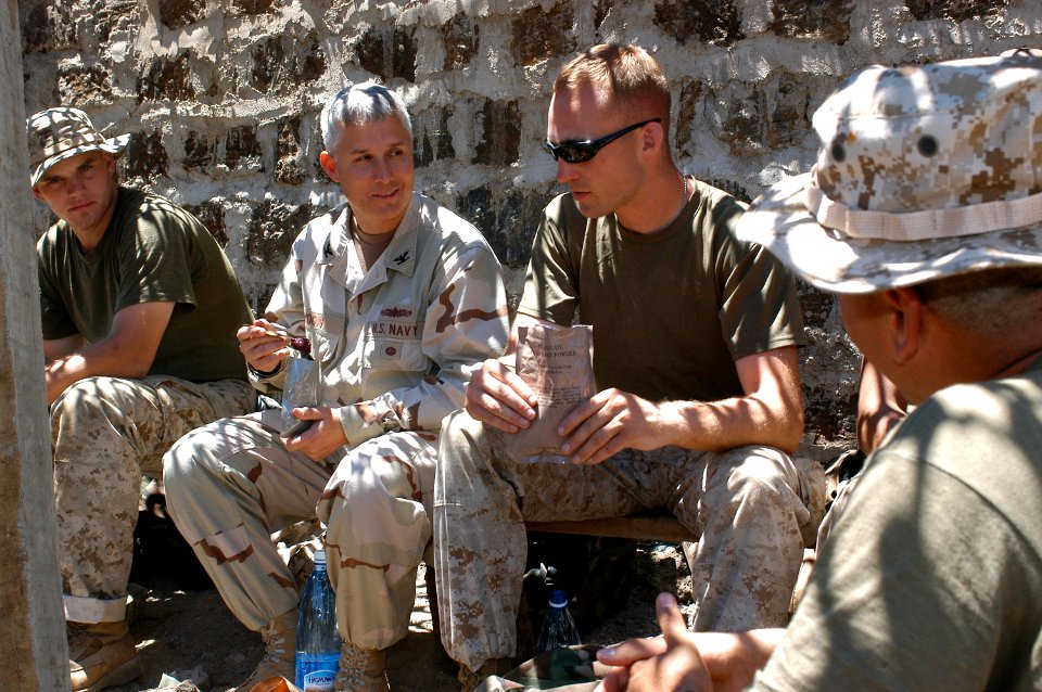 US Navy 060812-N-0411D-261 U.S. Navy Capt. Tim Moon, left center, chats with U.S. Marine Sgt. Jeremy Willett of Portland, Ore., about the improvements in the typical Meal Ready to Eat (MRE)