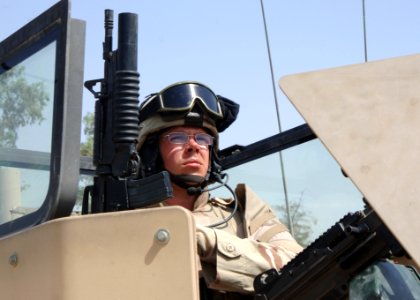 US Navy 060817-N-8623S-003 Gunner's Mate 1st Class Justin Hoffman, a native of Munising, Mich., mans the gun turret of a humvee while maintaining perimeter security in Al-Shuíllah, Iraq