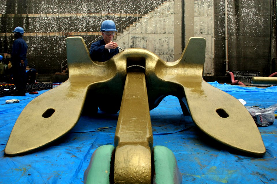 US Navy 060616-N-4953E-005 Boatswain's Mate 3rd Class Tyler Neve paints one of the 9000 pound Navy standard stockless anchors gold