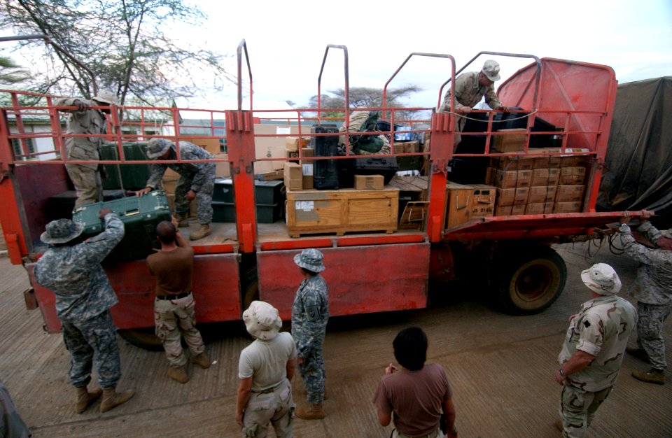 US Navy 060802-N-0411D-079 U.S. Service members unload supplies from trucks into a warehouse at Natural Fire headquarters before the start of the multi-national exercise