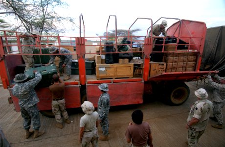 US Navy 060802-N-0411D-079 U.S. Service members unload supplies from trucks into a warehouse at Natural Fire headquarters before the start of the multi-national exercise