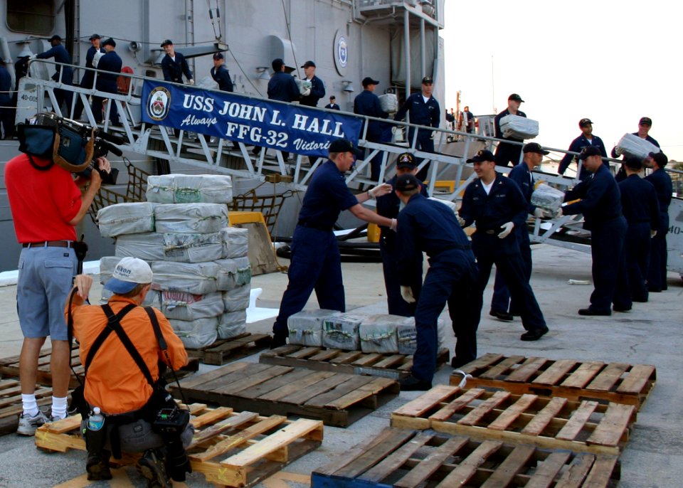 US Navy 060818-N-8544C-005 Sailors aboard the guided missile frigate USS John L. Hall (FFG 32) off-load 15,000 pounds of illegal drugs that were seized