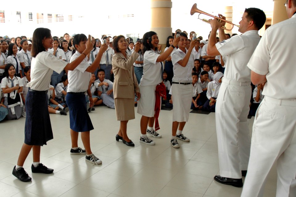 US Navy 060814-N-1577S-037 Navy Musician 2nd Class Brandon Barbie, with the U.S. Navy Show Band, performs a solo for students at SMB-1 Jr. High School during the Military Sealift Command (MSC) hospital ship USNS Mercy's (