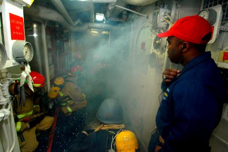 US Navy 060818-N-8604L-064 Senior Chief Damage Controlman Tyron Flynn supervises USS Kitty Hawk's (CV 63) at sea fire party, during a main space fire drill