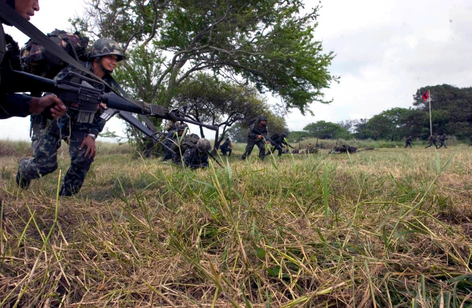 US Navy 060818-N-9851B-007 A platoon of Philippine Marines rush toward their objective during an exercise Cooperation Afloat Readiness and Training (CARAT) amphibious assault from dock landing ship USS Tortuga (LSD 46)