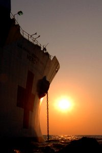 US Navy 060814-N-6501M-001 The morning sun rises off the bow of the Military Sealift Command (MSC) hospital ship USNS Mercy (T-AH 19), as crew members prepare for another full day of providing medical and dental care throughout