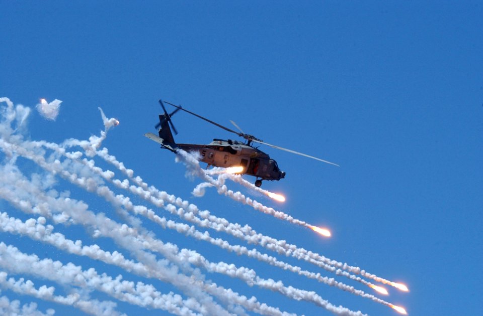 US Navy 060702-N-4776G-501 An HH-60H Seahawk assigned to Helicopter Anti-Submarine Warfare Squadron Four (HS-4), fires flairs during an air demonstration