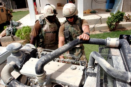 US Navy 060820-M-6150S-031 Navy Seabees from Navy Mobile Construction Battalion Four Zero (NMCB 40) in support of the First Armored Division (1 AD), work on a generator