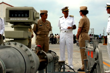 US Navy 060814-N-8539M-001 Commanding Officer, U.S. Naval Station Rota, Capt. Earl K. Hampton Jr., left, and Admiral-in-Chief, Rota Naval Base, Rear Adm. Ricardo Gomez Enriquez, center, discuss Rota's new underground fuel hydra