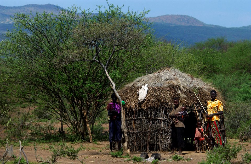 US Navy 060815-N-0411D-080 A family stands together in front of their small house watching the departure of American and East African Community forces from the Chemeril Dam area