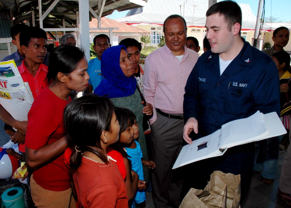 US Navy 060821-N-3931M-019 Navy Hospital Corpsman 3rd Class Christopher Thomas with the Medical Treatment Facility aboard the Military Sealift Command hospital ship USNS Mercy (T-AH 19), explains common English terms