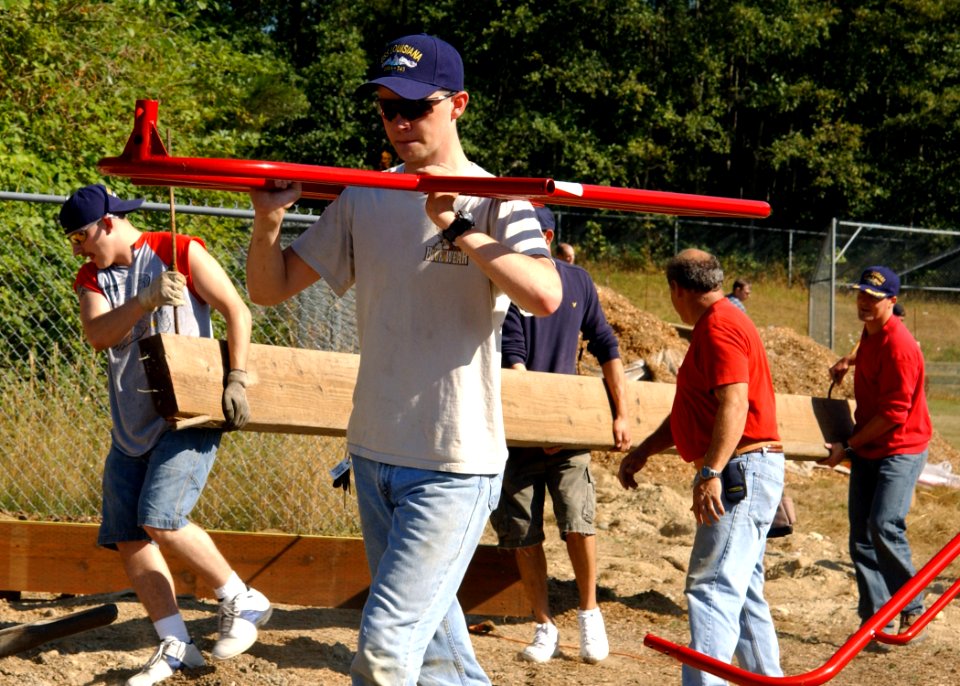 US Navy 060812-N-9190Q-004 Machinist's Mate Fireman Chance Dean Bridges, a native of Springtown, Texas, carries a piece of playground equipment during playground construction project at the Breidablik Elementary School