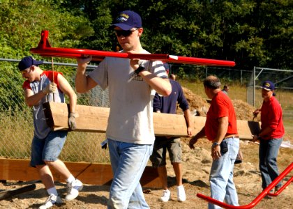 US Navy 060812-N-9190Q-004 Machinist's Mate Fireman Chance Dean Bridges, a native of Springtown, Texas, carries a piece of playground equipment during playground construction project at the Breidablik Elementary School