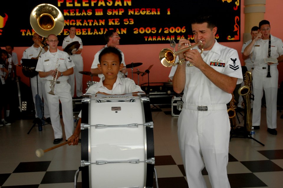 US Navy 060814-N-1577S-071 Navy Musician 2nd Class Brandon Barbie, with the U.S. Navy Show Band, performs a solo for students at SMB-1 Jr. High School during the Military Sealift Command (MSC) hospital ship USNS Mercy's (
