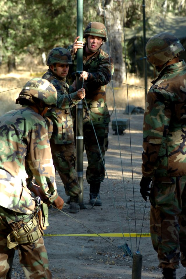 US Navy 060815-N-0775Y-058 Right, Information Technician 1st Class Daniel Ramsey and Personnelmen Specialist 2nd Class Francisco Bazavilvazo erect a communication antenna for at the Logistics Support Area (LSA)