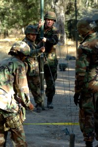 US Navy 060815-N-0775Y-058 Right, Information Technician 1st Class Daniel Ramsey and Personnelmen Specialist 2nd Class Francisco Bazavilvazo erect a communication antenna for at the Logistics Support Area (LSA)