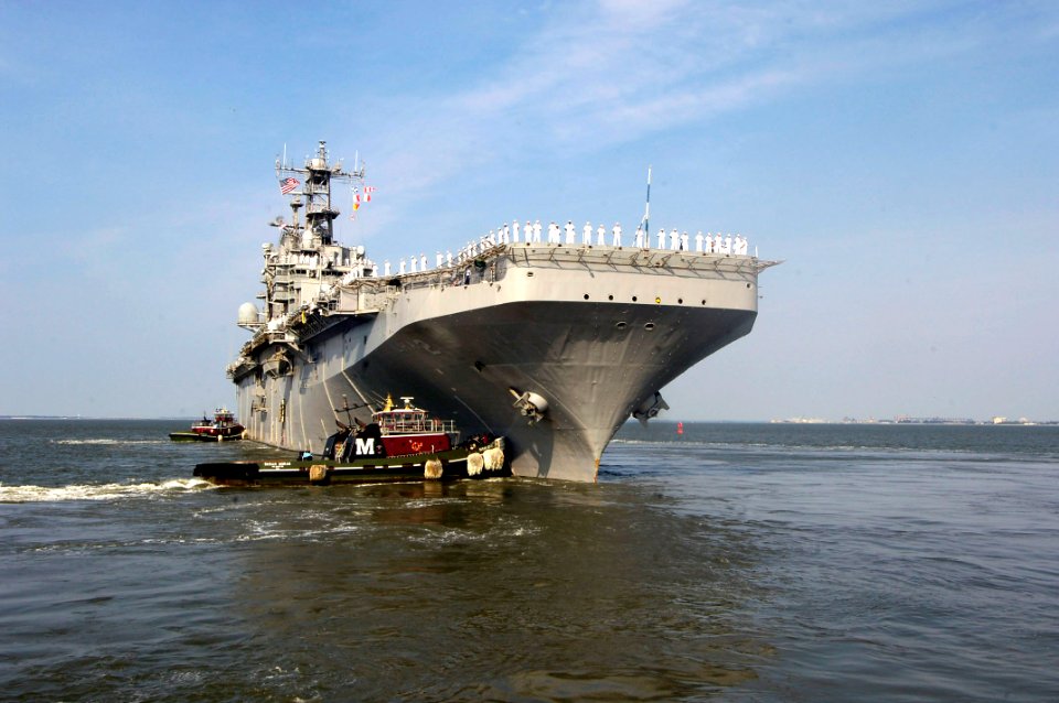 US Navy 060815-N-5555T-006 Tugboats assist the amphibious assault ship USS Saipan (LHA 2) as it departs Naval Station Norfolk