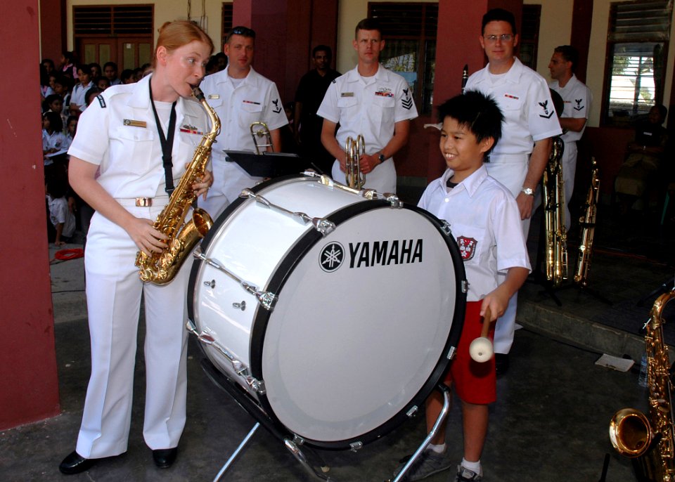 US Navy 060823-N-3931M-187 A local student plays the bass drum alongside Navy Musician 2nd Class Kerry Mahaffey of Wilmington, W.V