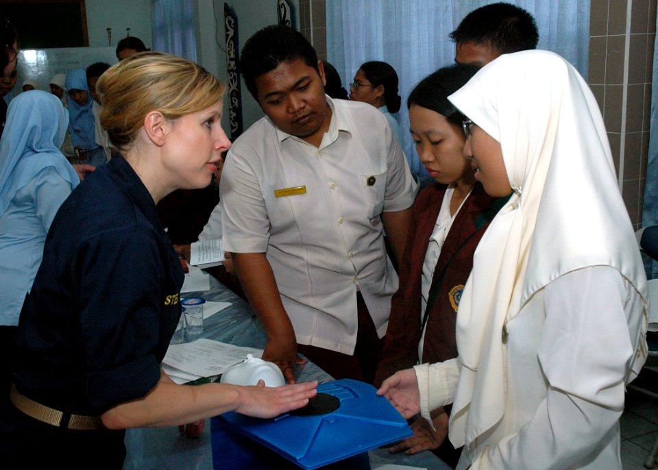 US Navy 060815-N-3931M-024 Navy Lt. Susan Steinman from the Medical Treatment Facility aboard the Military Sealift Command (MSC) hospital ship USNS Mercy (T-AH 19), explains basic CPR techniques to local residents at the RSUD T
