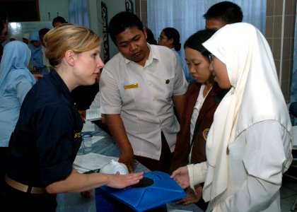 US Navy 060815-N-3931M-024 Navy Lt. Susan Steinman from the Medical Treatment Facility aboard the Military Sealift Command (MSC) hospital ship USNS Mercy (T-AH 19), explains basic CPR techniques to local residents at the RSUD T