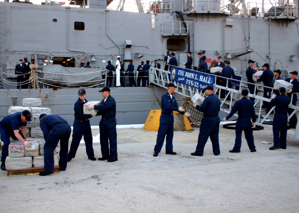 US Navy 060818-N-8544C-009 Sailors aboard the guided missile frigate USS John L. Hall (FFG 32) off-load 15,000 pounds of illegal drugs that were seized in two separate interagency busts
