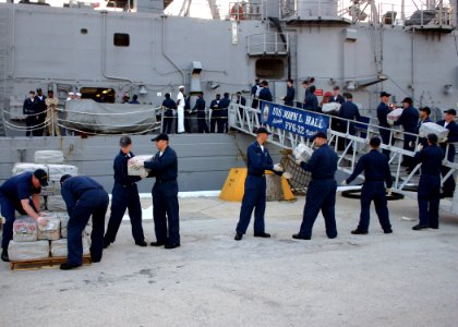 US Navy 060818-N-8544C-009 Sailors aboard the guided missile frigate USS John L. Hall (FFG 32) off-load 15,000 pounds of illegal drugs that were seized in two separate interagency busts