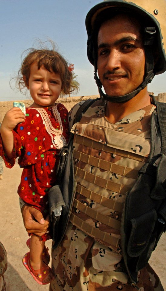 US Navy 060816-N-4097B-030 An Iraqi army soldier from 3rd Battalion, 3rd Brigade, 5th Iraqi Army Division holds a small girl during a visit to a village outside Mujahida, Iraq