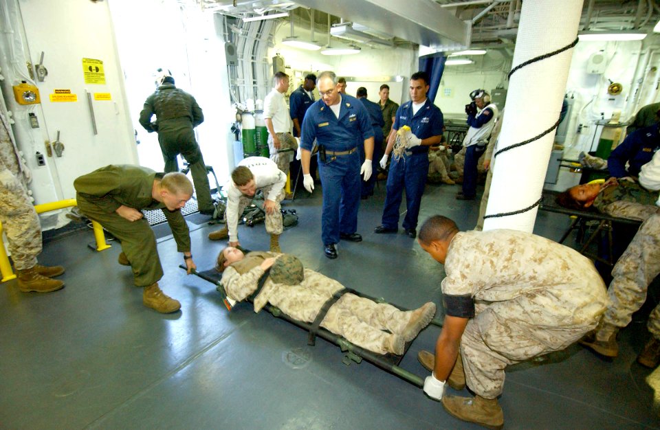 US Navy 060817-N-4482V-006 Members of Expeditionary Strike Group Five's (ESG-5) medical team, attached to USS Boxer (LHD 4), assist wounded Marines during a mass casualty drill