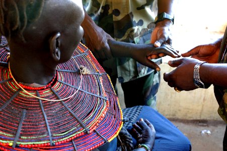 US Navy 060812-N-0411D-312 A Tanzanian Army doctor assesses the severity of a fracture of a Pokot woman's left arm photo