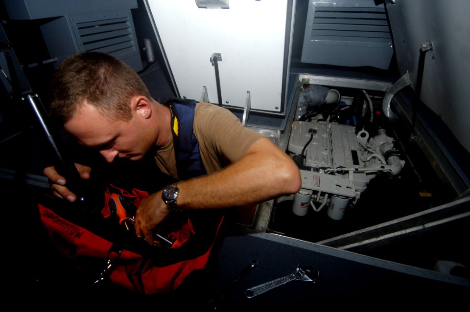 US Navy 060825-N-5555T-009 Engineman 2nd Class Jeremy Vittitow performs maintenance on a SeaArk rigid inflatable boats belonging to Inshore Boat Unit Four One (IBU-41) and Inshore Boat Unit Four Two (IBU-42)