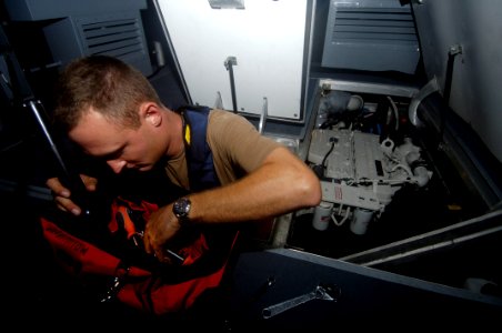 US Navy 060825-N-5555T-009 Engineman 2nd Class Jeremy Vittitow performs maintenance on a SeaArk rigid inflatable boats belonging to Inshore Boat Unit Four One (IBU-41) and Inshore Boat Unit Four Two (IBU-42)