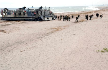 US Navy 060818-N-9851B-005 Philippine Marines debark landing craft air cushion Five Seven (LCAC 57) from Assault Craft Unit 5 during an exercise Cooperation Afloat Readiness and Training (CARAT) amphibious assault from dock lan