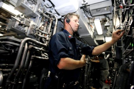 US Navy 060825-N-7441H-011 Petty Officer 1st class Raymond Monk assists in a shipboard test evolution aboard the Virginia-class attack submarine USS Texas (SSN 775)