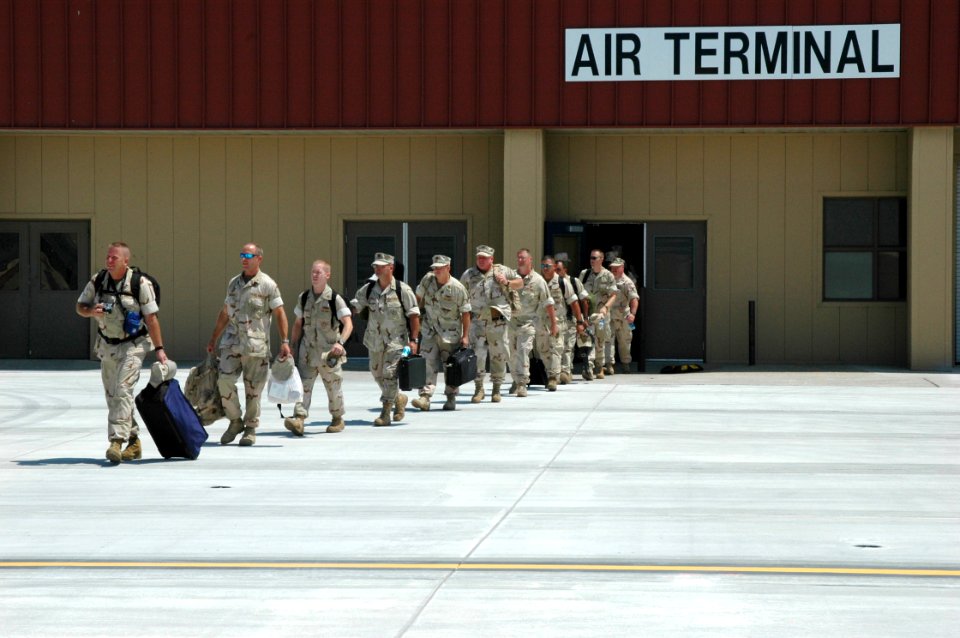 US Navy 060822-N-9195K-002 Sailors from the Navy and Coast Guard assigned to Naval Coastal Warfare Squadron Three Four (NCWRON-34) file out of the air terminal at Naval Air Station North Island as they prepare to depart for Kuw