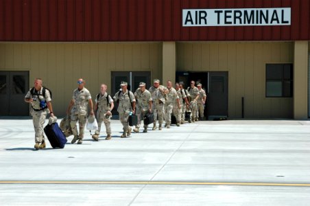 US Navy 060822-N-9195K-002 Sailors from the Navy and Coast Guard assigned to Naval Coastal Warfare Squadron Three Four (NCWRON-34) file out of the air terminal at Naval Air Station North Island as they prepare to depart for Kuw
