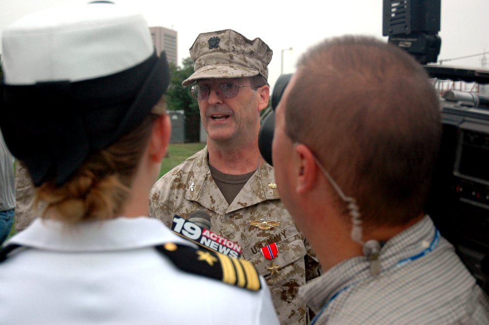 US Navy 060828-N-1805P-004 Medical Corps Navy Reserve Capt. Matthew Gratton answers questions from local media after being awarded a Bronze Star by Chief of Naval Personnel, Vice Adm. John C. Harvey Jr., during opening ceremoni