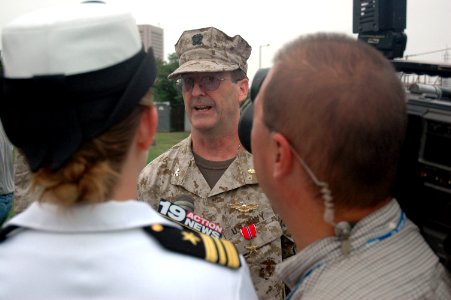 US Navy 060828-N-1805P-004 Medical Corps Navy Reserve Capt. Matthew Gratton answers questions from local media after being awarded a Bronze Star by Chief of Naval Personnel, Vice Adm. John C. Harvey Jr., during opening ceremoni