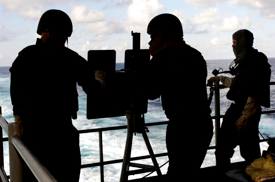 US Navy 060822-N-8591H-003 Weapons department Sailors prepare a .50-caliber machine gun for a live fire exercise aboard the conventionally-powered aircraft carrier USS Kitty Hawk (CV 63)