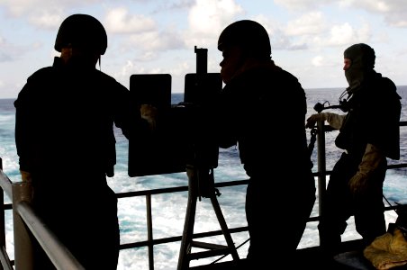 US Navy 060822-N-8591H-003 Weapons department Sailors prepare a .50-caliber machine gun for a live fire exercise aboard the conventionally-powered aircraft carrier USS Kitty Hawk (CV 63)
