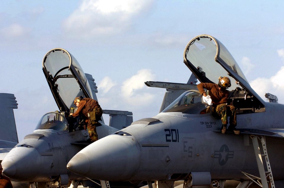 US Navy 060823-N-8604L-026 Air wing Sailors embarked aboard the conventionally-powered aircraft carrier USS Kitty Hawk (CV 63) clean the canopy and cockpit of F-A-18 Super Hornets