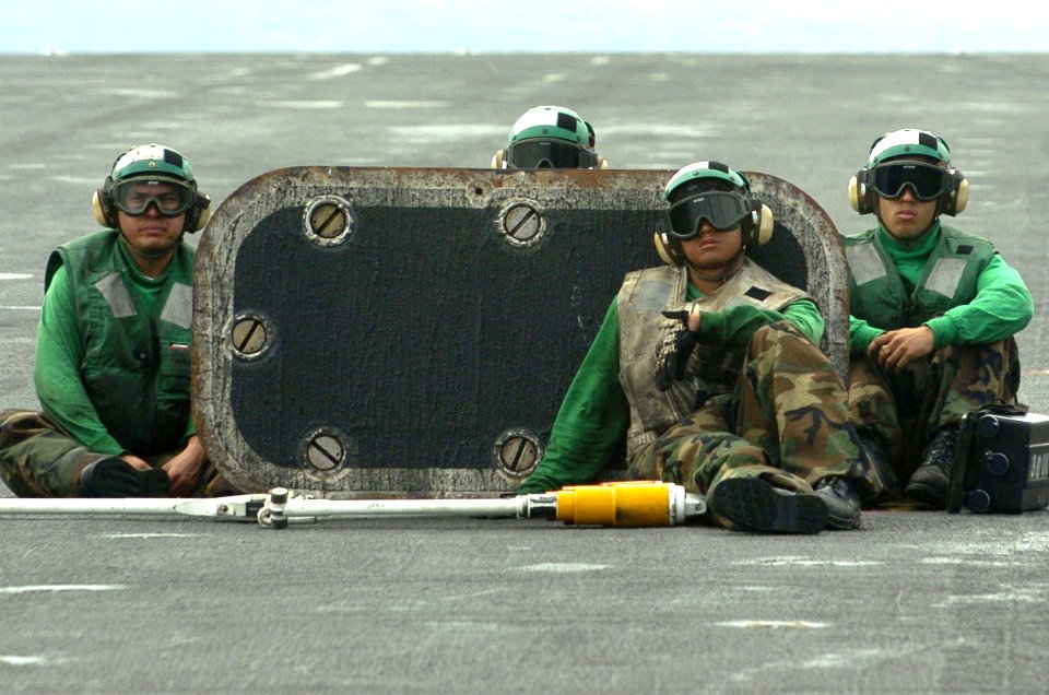 US Navy 060824-N-8604L-240 USS Kitty Hawk (CV 63) Flight deck personnel watch as a C-2A Greyhound assigned to Fleet Logistics Support Squadron Three Zero (VRC-30) prepare for launch on the flight deck