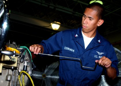 US Navy 060817-N-1810F-023 Aviation Machinist Mate 3rd Class Marlo Cerado disassembles a SH-60B Seahawk Helicopter engine, for inspection and cleaning
