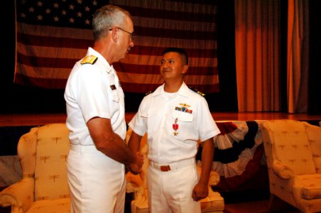 US Navy 060829-N-5758H-025 Director, Fleet Maintenance, Commander, U.S. Fleet Forces Command, Rear Adm. Jeffrey A. Brooks, presents the Bronze Star medal to Lt. Cmdr. Benito E. Baylosis