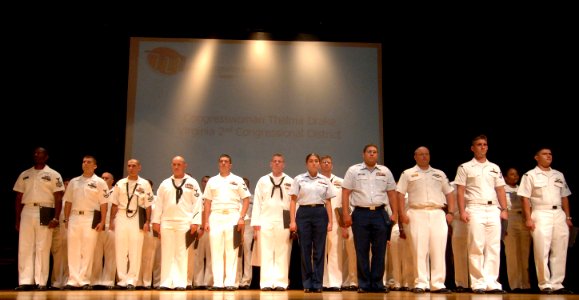 US Navy 060824-N-5758H-061 Sailors, Marines and Coast Guard personnel stand at attention as they receive congratulatory remarks for their outstanding performance during the Military Recognition Reception at Crispus Attucks Cult