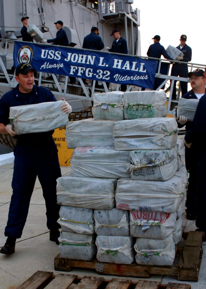US Navy 060818-N-8544C-004 Sailors aboard the guided missile frigate USS John L. Hall (FFG 32) off-load 15,000 pounds of illegal drugs that were seized