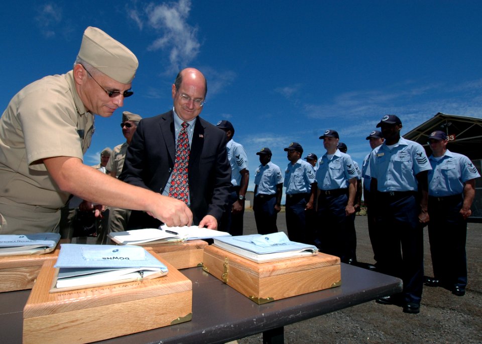 US Navy 060822-N-4965F-003 Secretary of the Navy (SECNAV), the Honorable Dr. Donald C. Winter, signs charge books of chief petty officer selects during a visit to Naval Computer and Telecommunications Area Master Station, Pacif