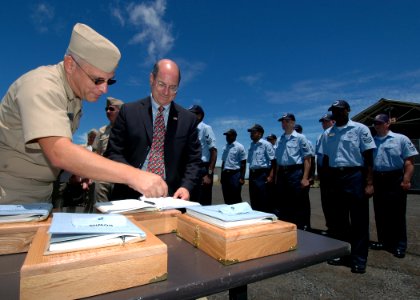 US Navy 060822-N-4965F-003 Secretary of the Navy (SECNAV), the Honorable Dr. Donald C. Winter, signs charge books of chief petty officer selects during a visit to Naval Computer and Telecommunications Area Master Station, Pacif